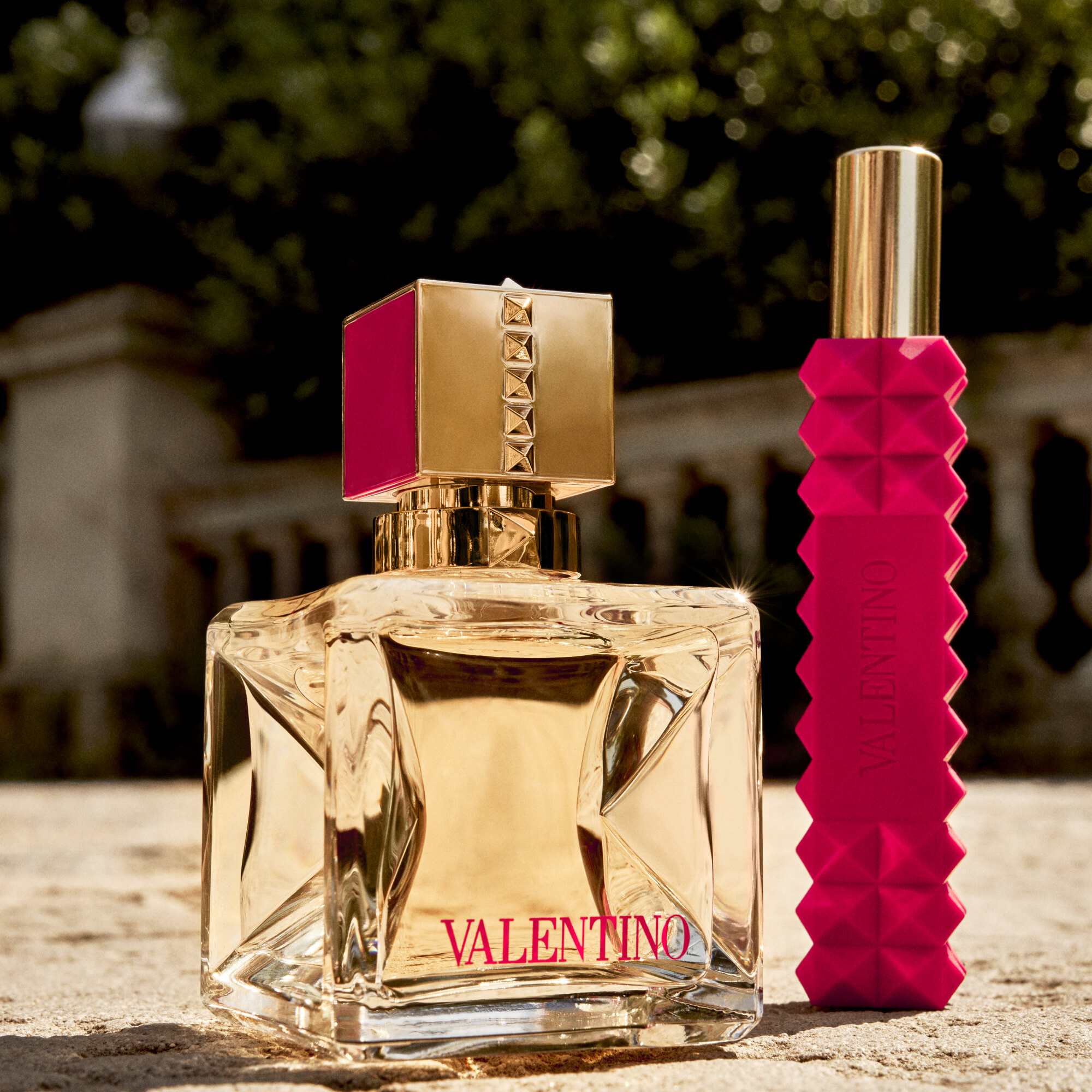A 50ml bottle and a 10ml roller ball of Voce Viva Eau De Parfum on the ground